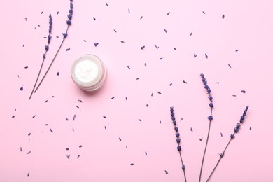 Photo of Jar of cream and lavender flowers on pink background, flat lay