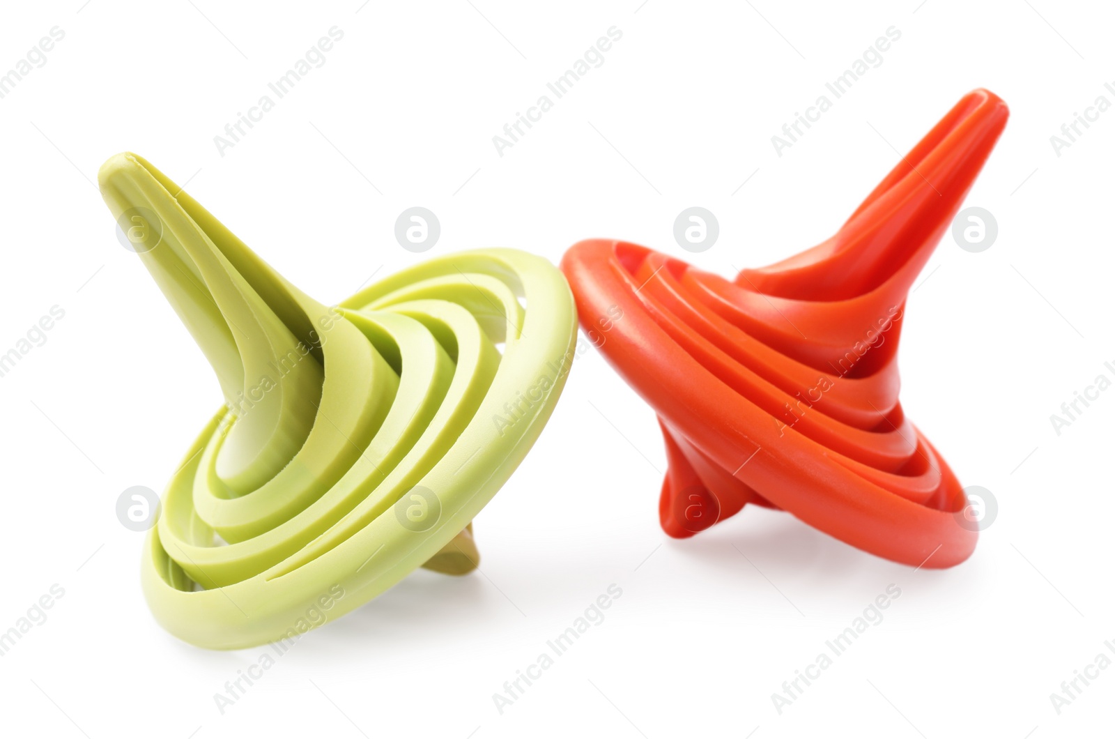 Photo of Two colorful spinning tops on white background