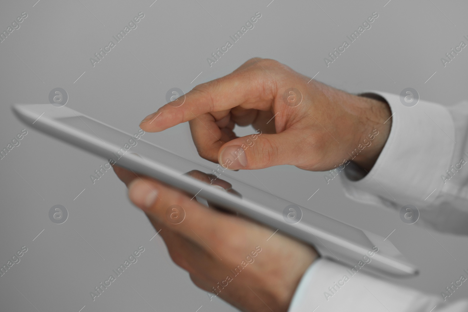 Photo of Closeup view of man using new tablet indoors