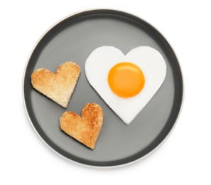 Photo of Plate with heart shaped fried egg and toasts isolated on white, top view