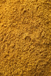 Photo of Aromatic turmeric powder as background, top view