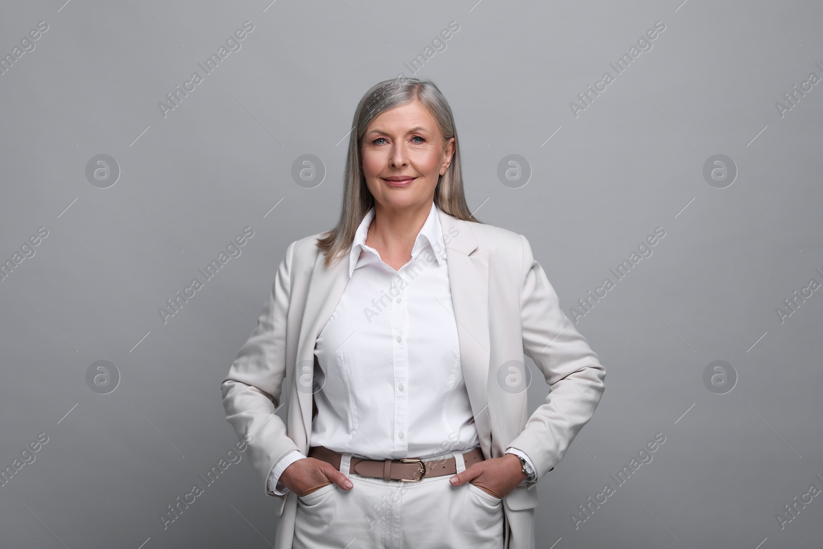 Photo of Portrait of beautiful senior woman on grey background