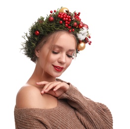 Beautiful young woman wearing Christmas wreath on white background