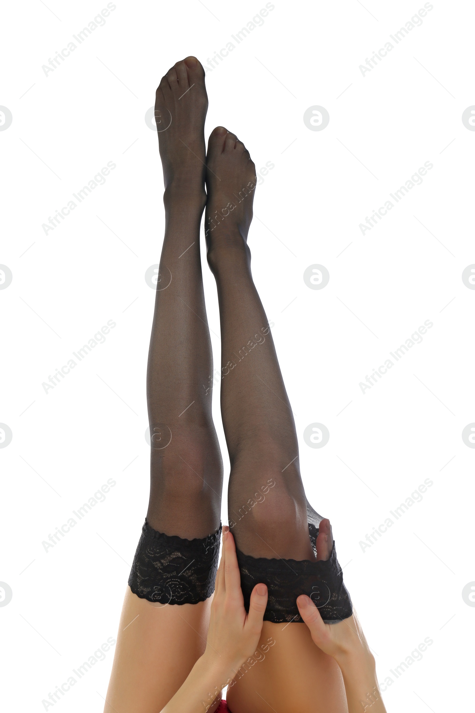 Photo of Young woman putting on stocking against white background, closeup