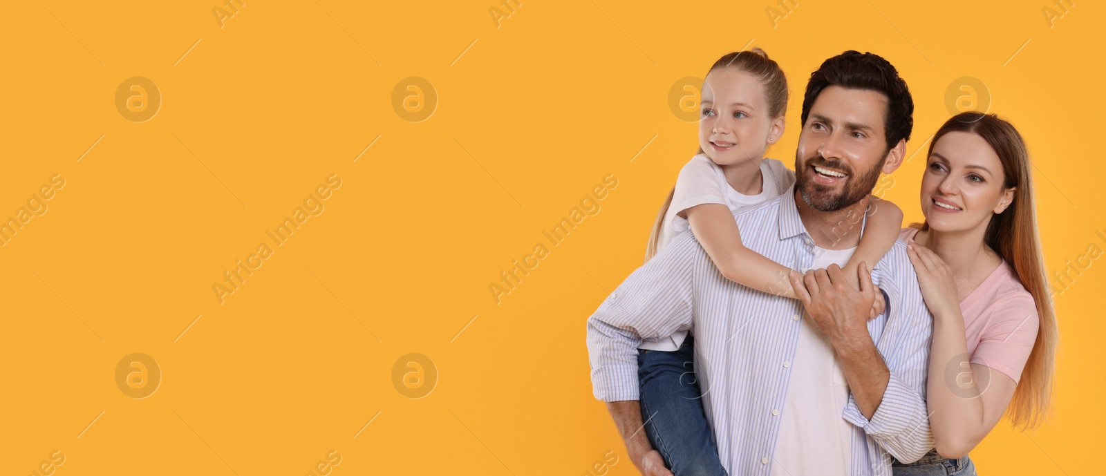 Image of Happy family with child on orange background, space for text. Banner design