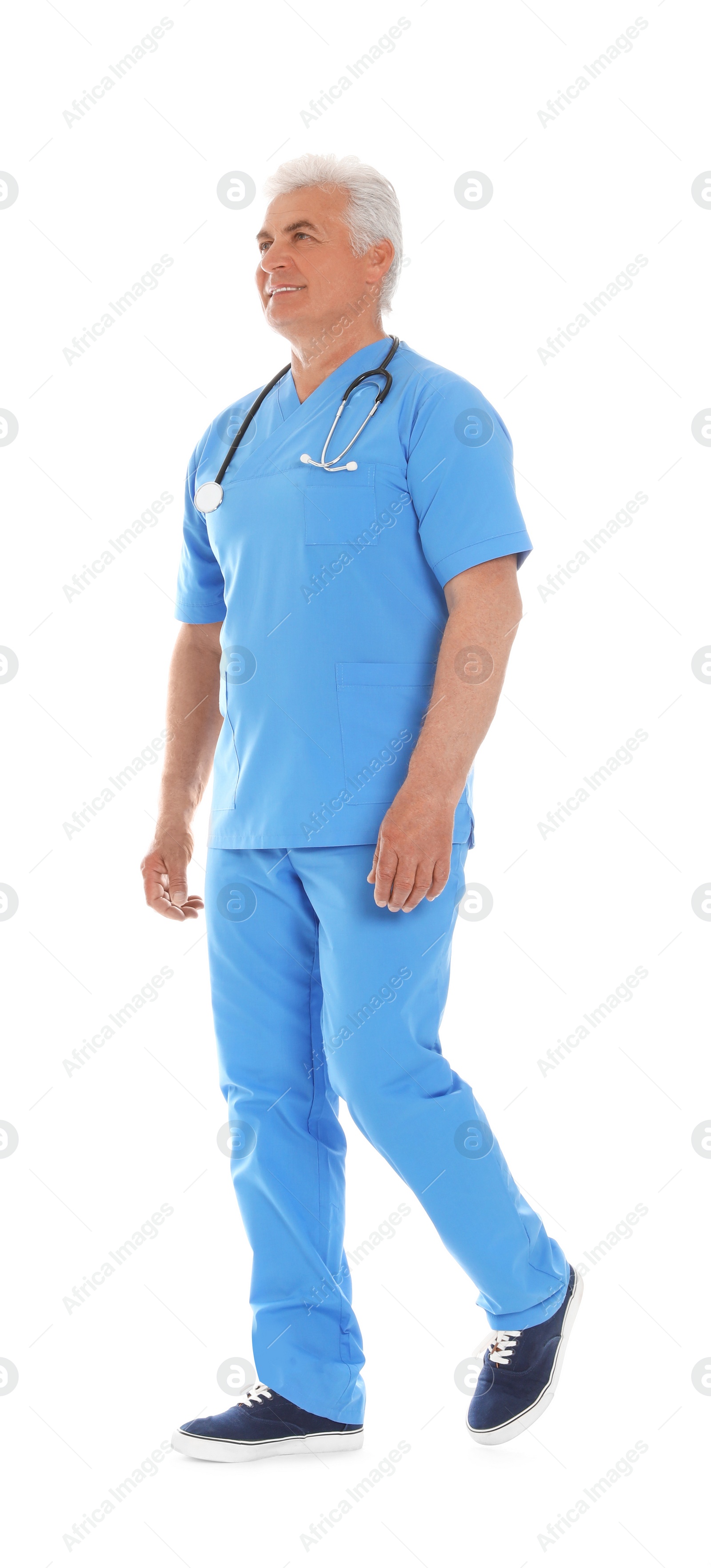 Photo of Full length portrait of male doctor in scrubs with stethoscope isolated on white. Medical staff