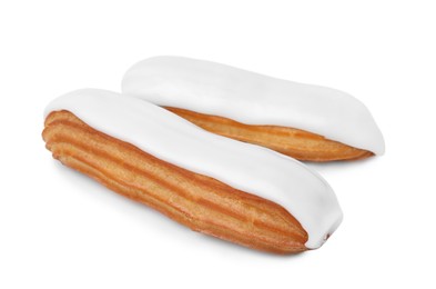 Photo of Two delicious eclairs covered with glaze isolated on white