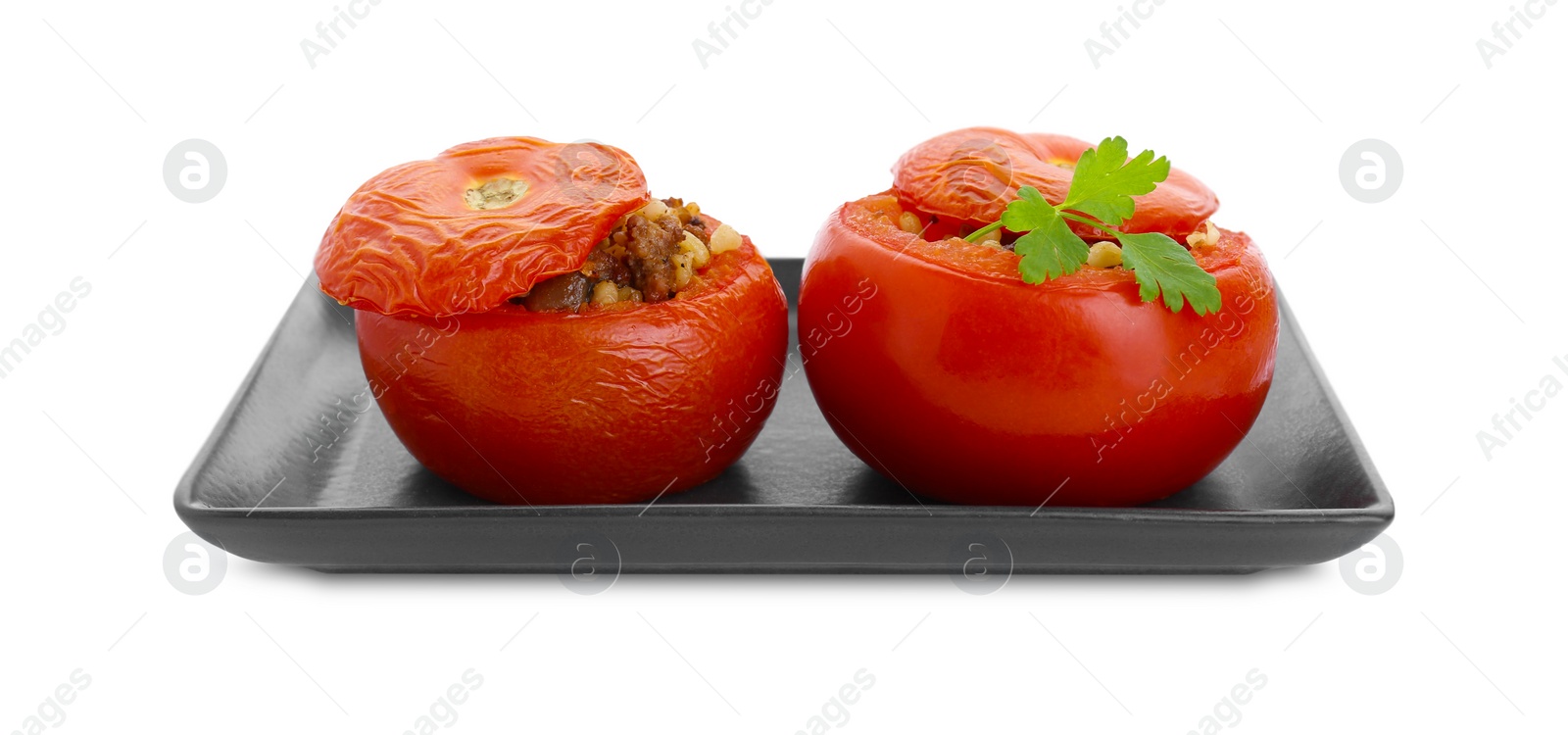 Photo of Plate of delicious stuffed tomatoes isolated on white