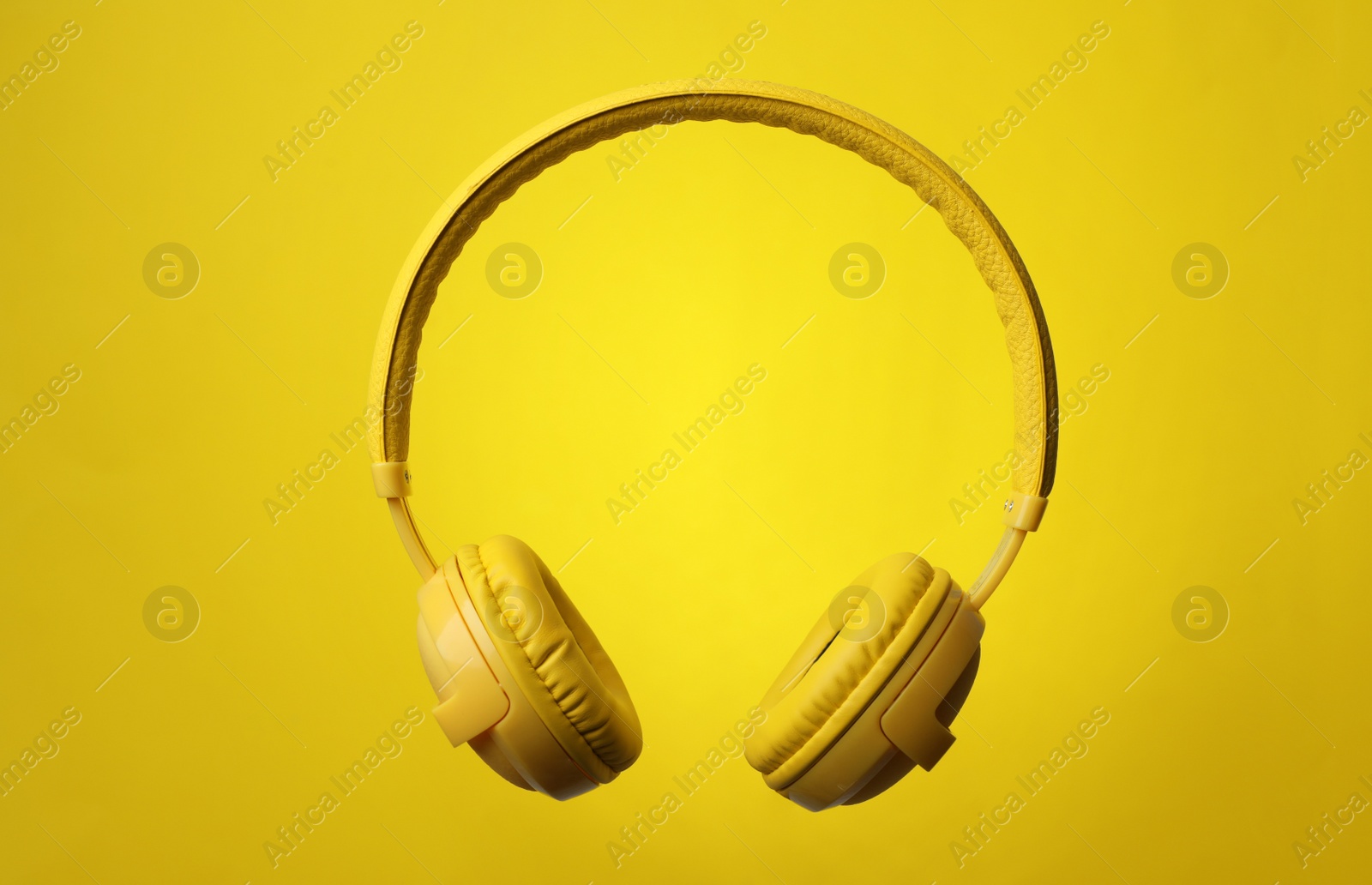 Photo of Stylish modern headphones with earmuffs on color background