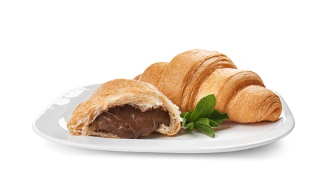 Photo of Tasty croissants with chocolate on plate against white background