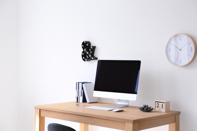 Comfortable workplace with computer on desk in home office