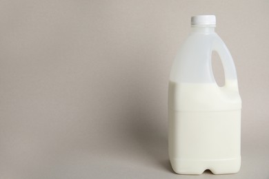 Photo of Gallon bottle of milk on beige background. Space for text