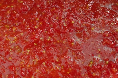 Red tomato juice as background, closeup view