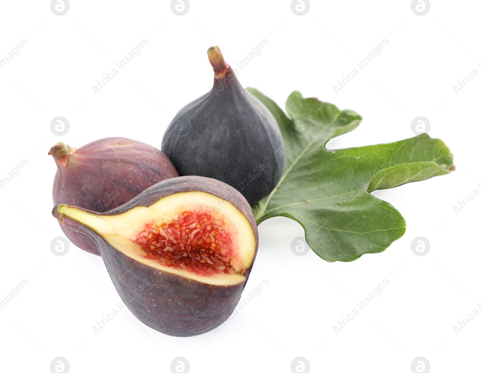 Photo of Whole and cut tasty fresh figs with green leaf isolated on white