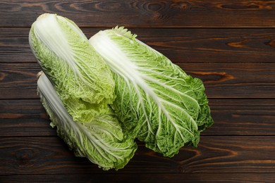 Photo of Fresh ripe Chinese cabbages on wooden table