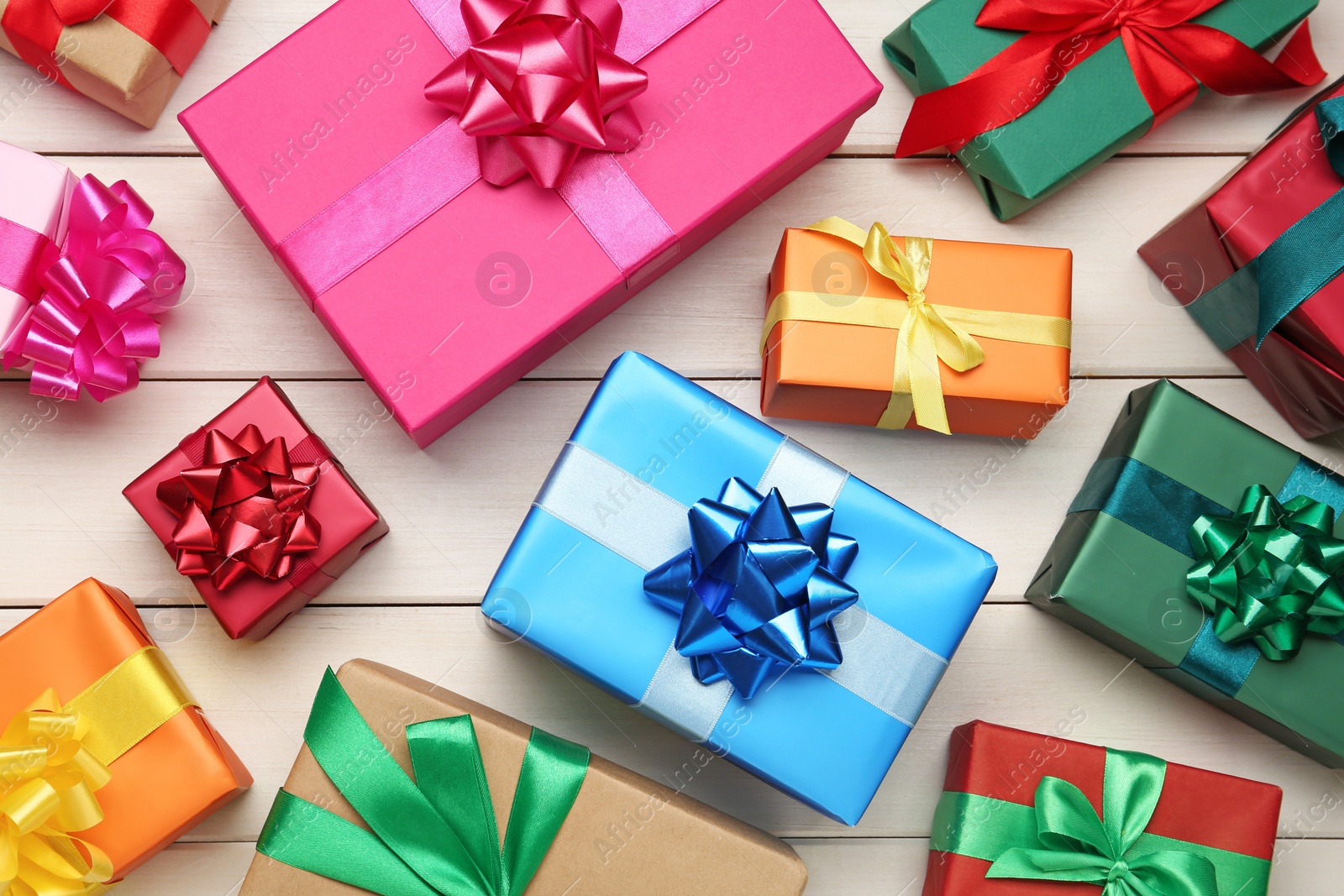 Photo of Many colorful gift boxes on white wooden table, flat lay