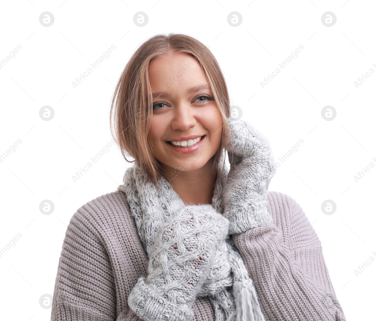 Photo of Young woman in warm sweater, mittens and scarf on white background. Winter season