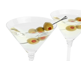 Photo of Martini cocktail with olives on white background