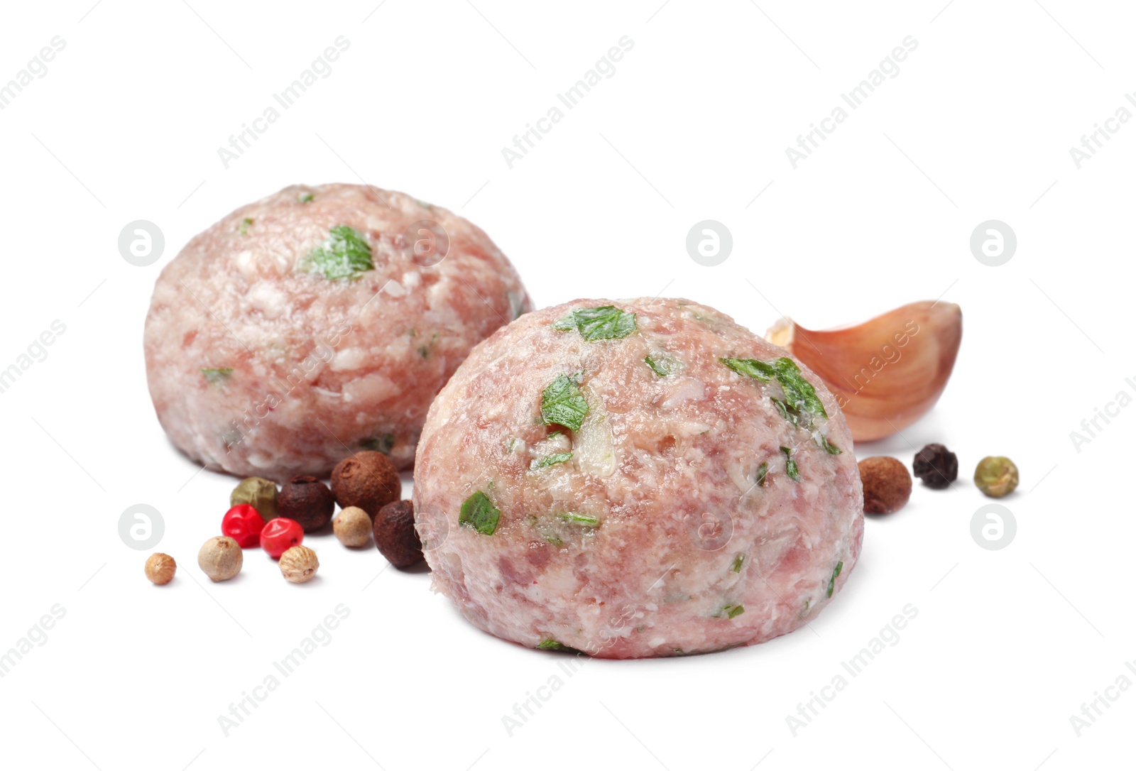 Photo of Fresh raw meatballs and spices on white background