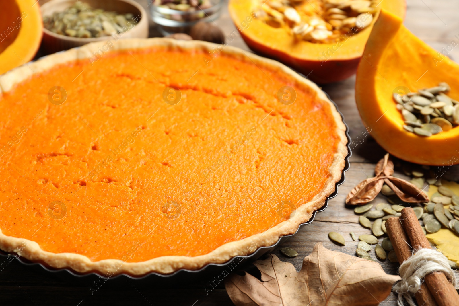 Photo of Delicious homemade pumpkin pie on wooden table, closeup