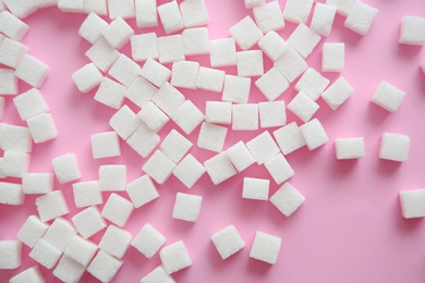 Photo of Refined sugar cubes on color background, top view