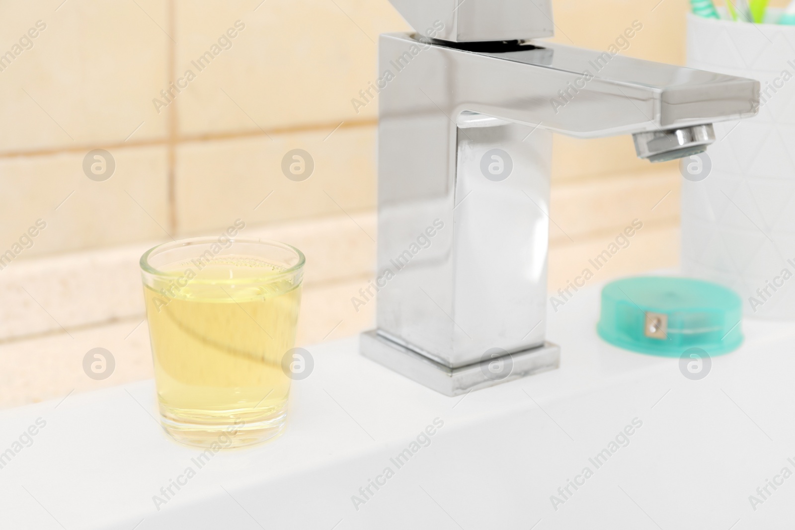 Photo of Mouthwash near tap on sink in bathroom. Teeth and oral care