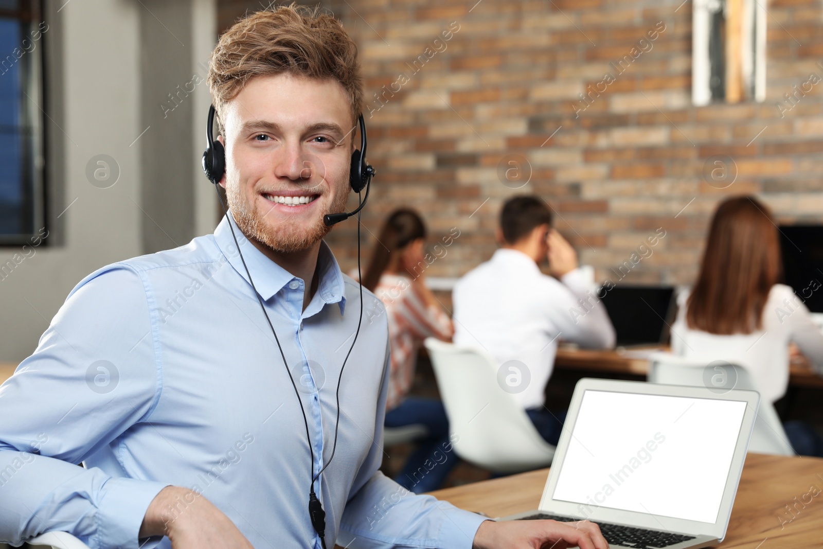 Photo of Technical support operator with headset in modern office