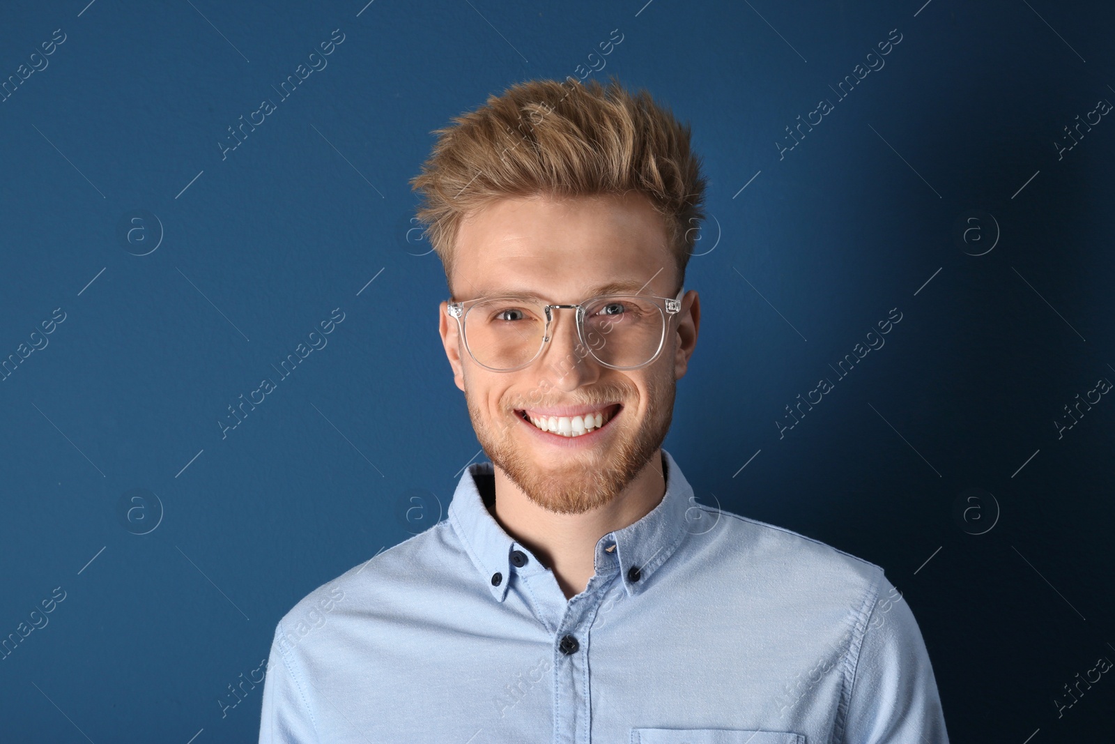 Photo of Portrait of handsome young man on blue background