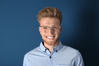 Portrait of handsome young man on blue background