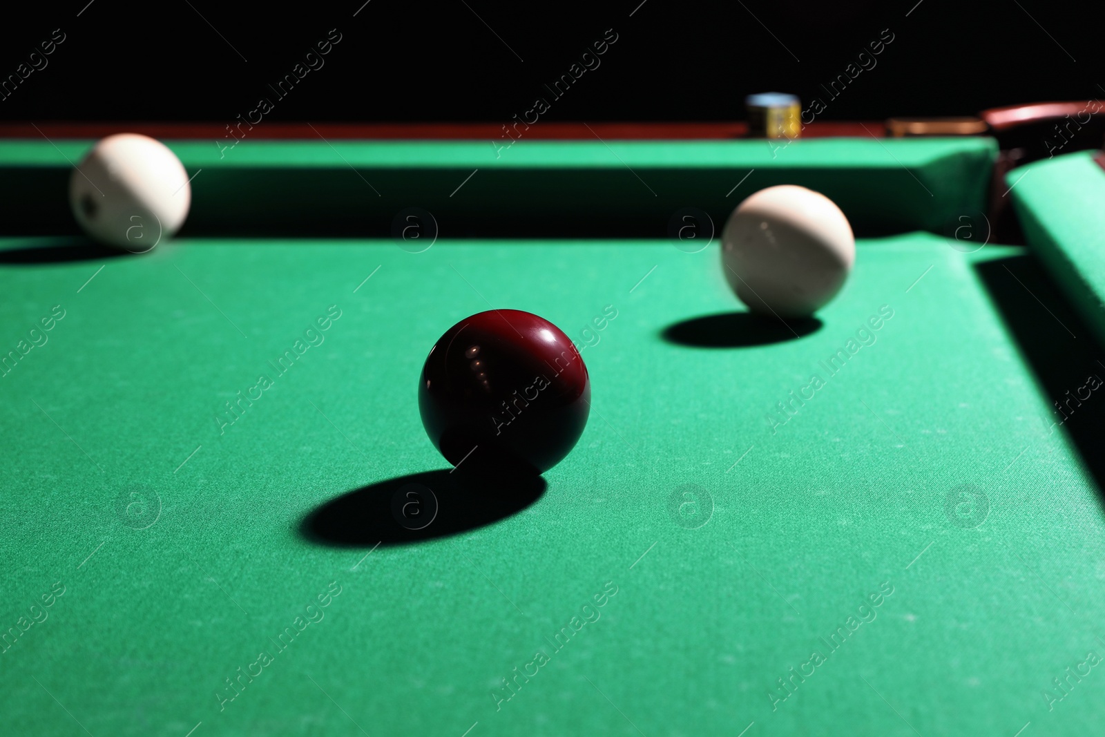 Photo of Balls and chalk on modern billiard table