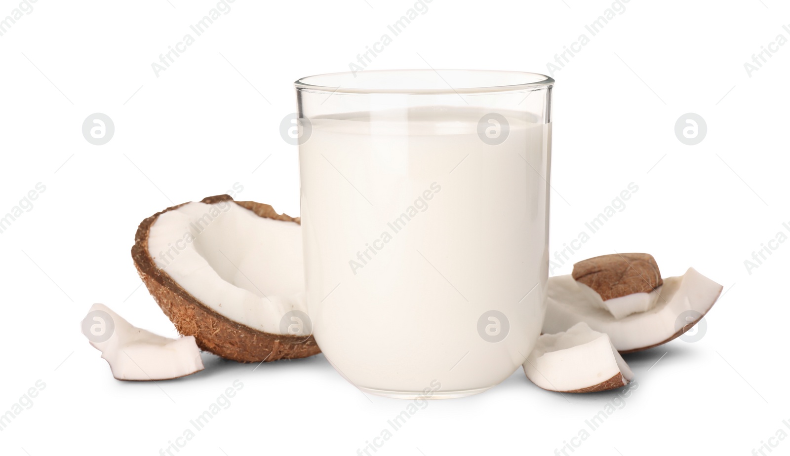 Photo of Glass of delicious vegan milk and coconut pieces on white background