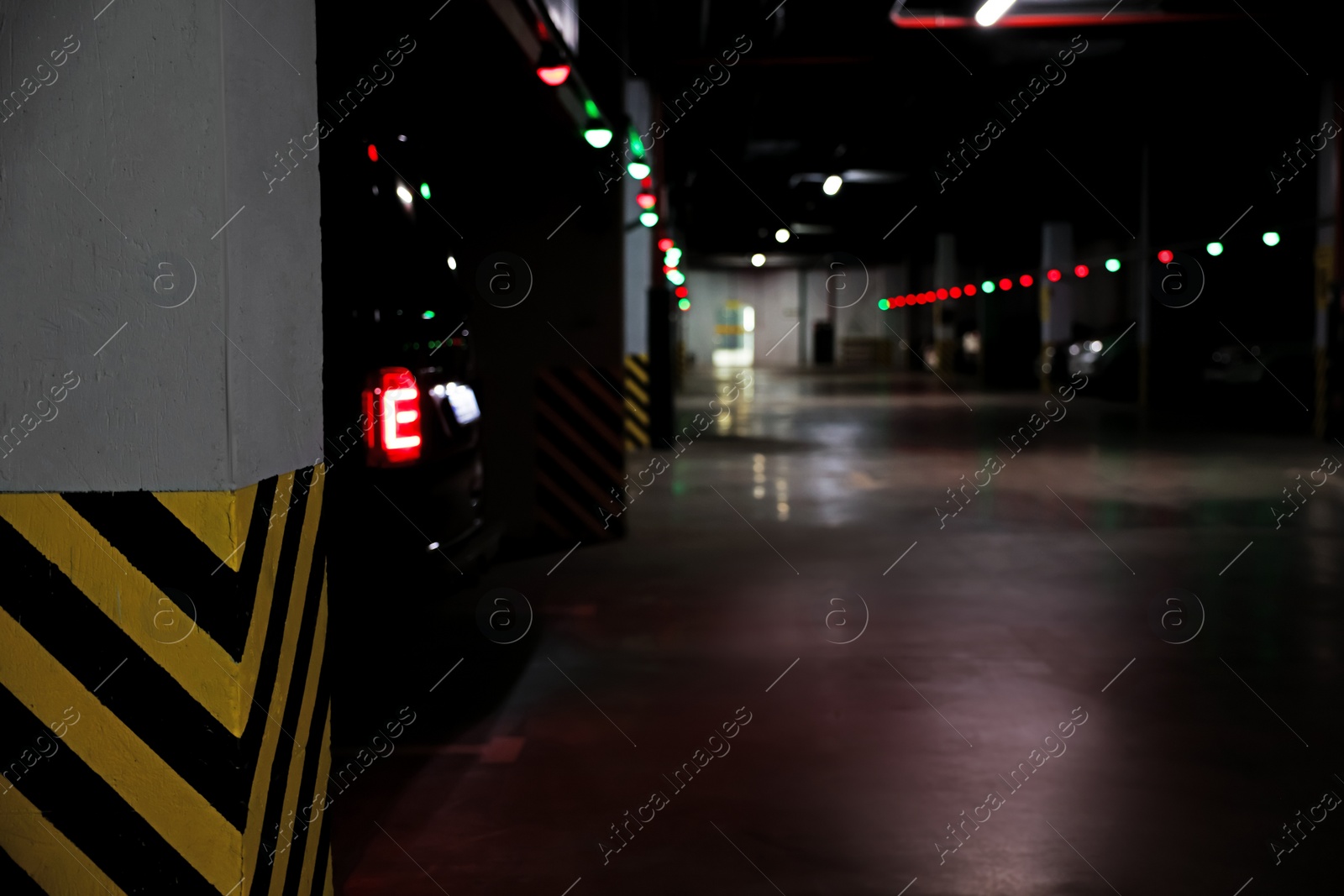 Photo of Modern parking garage with cars at night