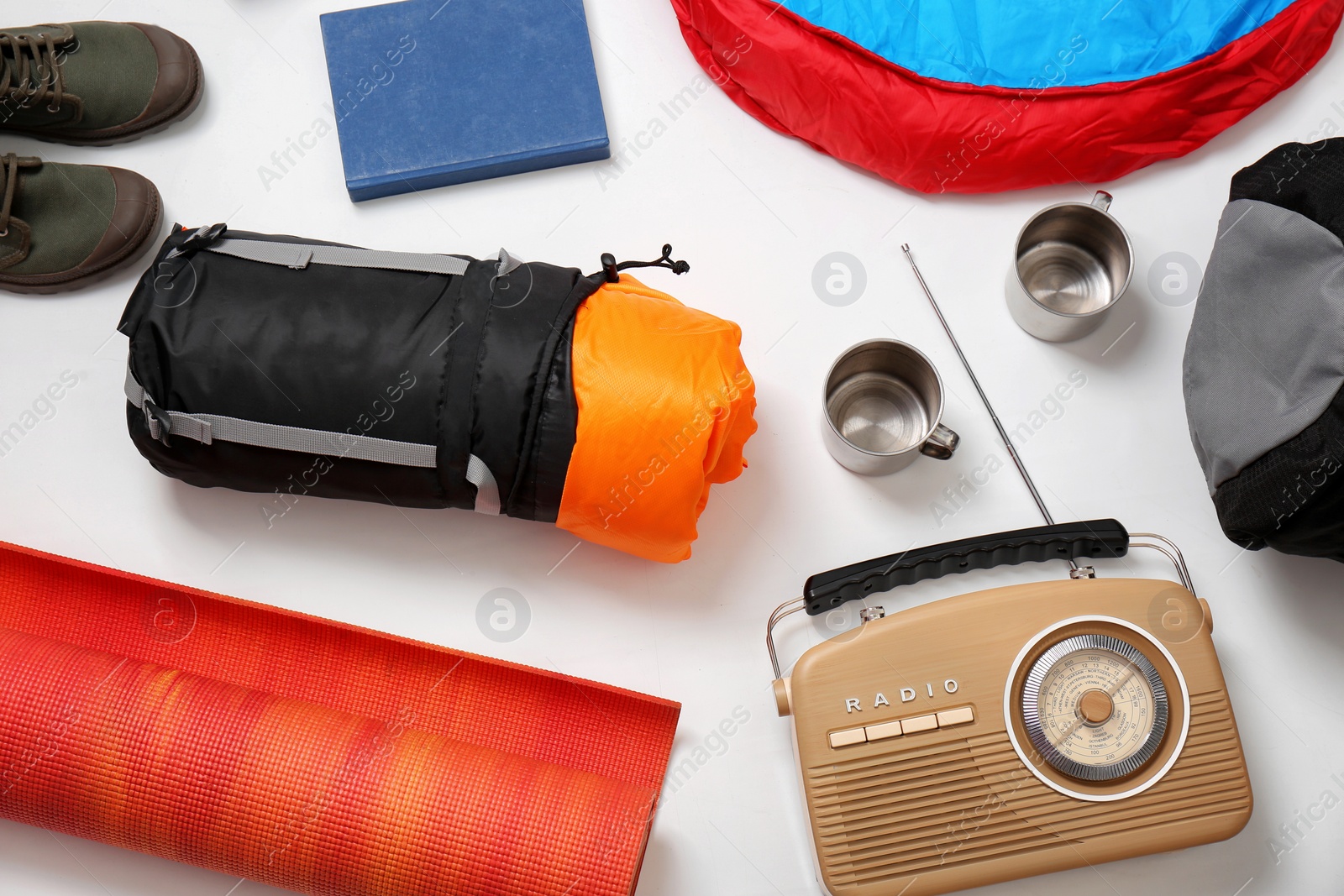 Photo of Flat lay composition with camping equipment on white background