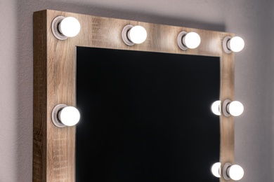 Photo of Beautiful mirror in modern makeup room, closeup