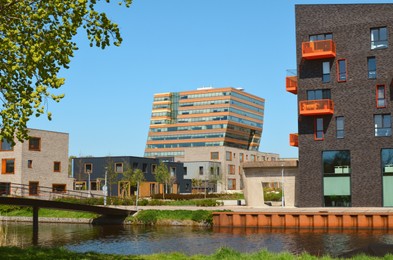 Photo of Cityscape with beautiful modern buildings and canal on sunny day