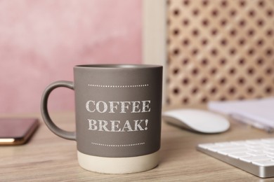 Mug with inscription Coffee Break on wooden table