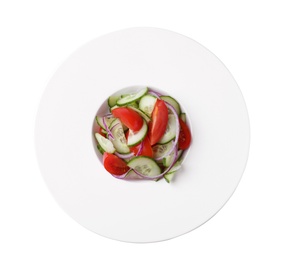 Delicious fresh cucumber tomato salad in plate on white background, top view