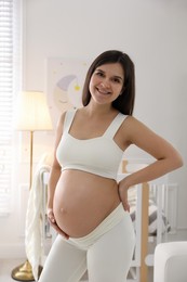 Photo of Happy pregnant woman at home. Choosing baby name