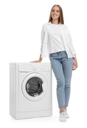 Beautiful young woman near washing machine on white background