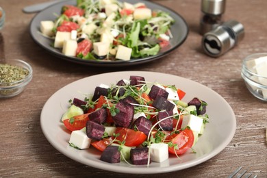 Photo of Delicious carrot salad served on wooden table, closeup