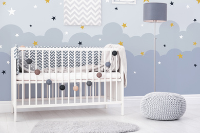 Image of Baby room interior with comfortable crib 