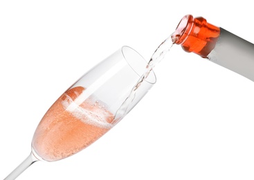 Rose champagne pouring from bottle into glass isolated on white