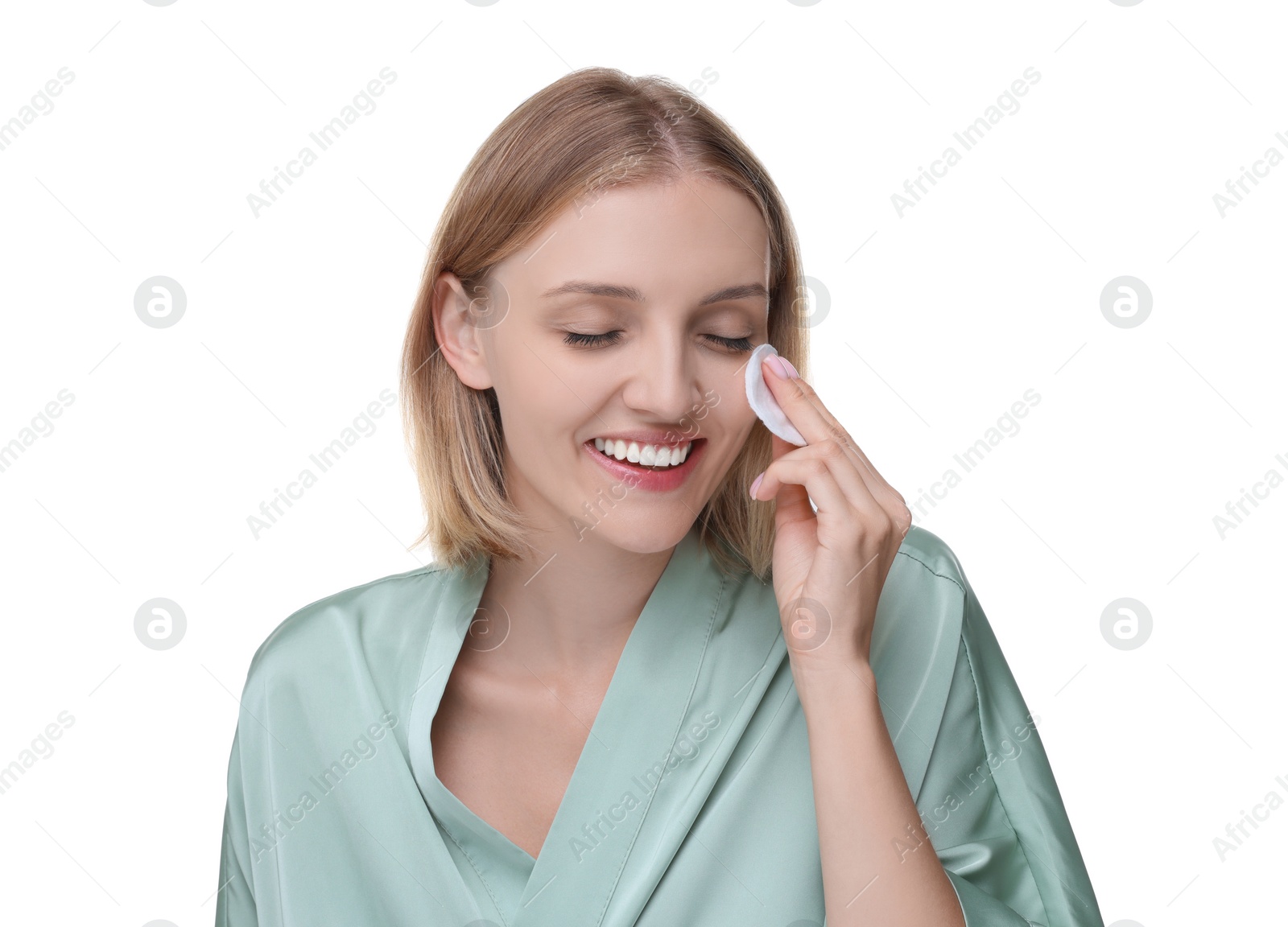 Photo of Young woman cleaning her face with cotton pad on white background