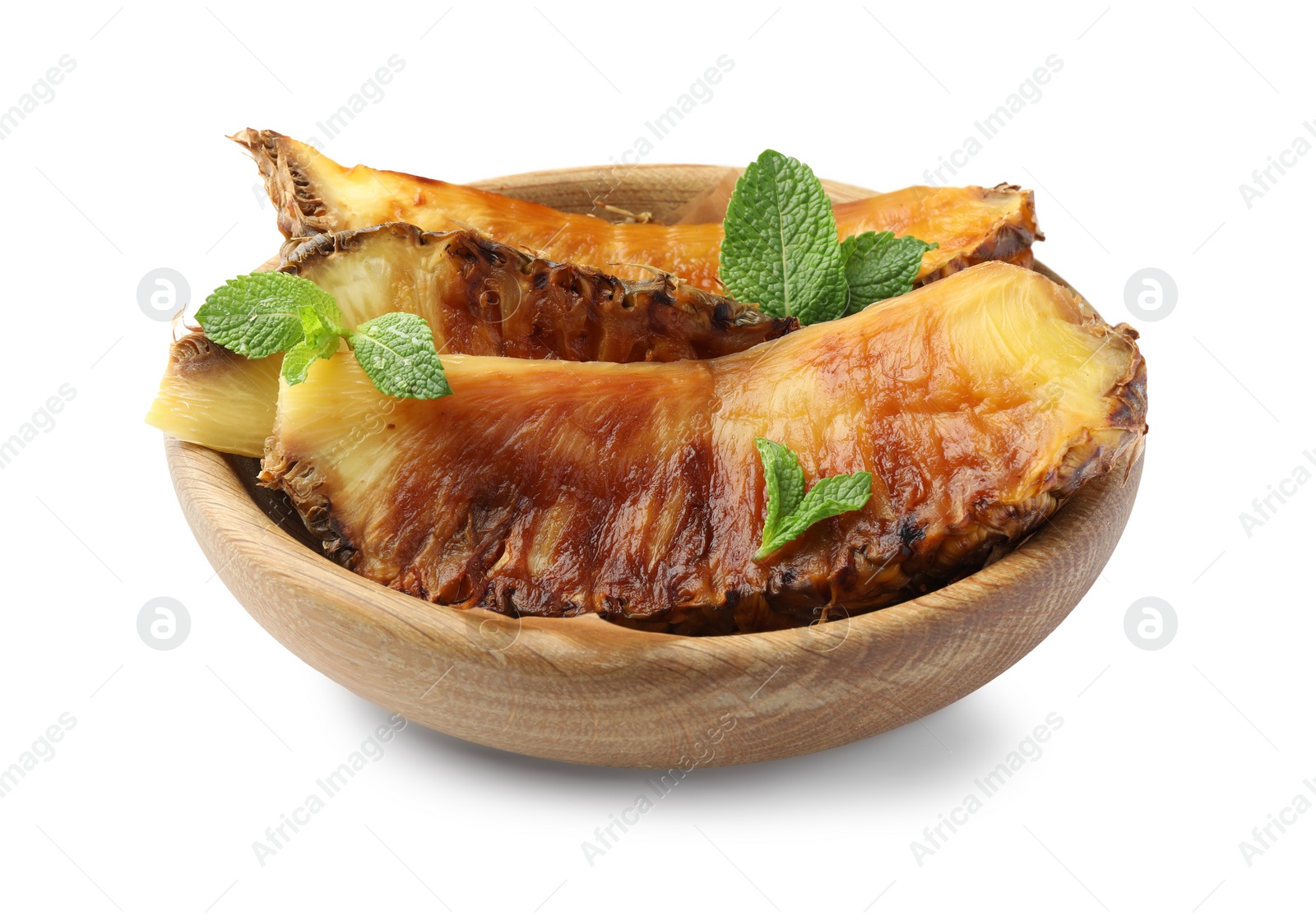 Photo of Tasty grilled pineapples with mint in wooden bowl isolated on white