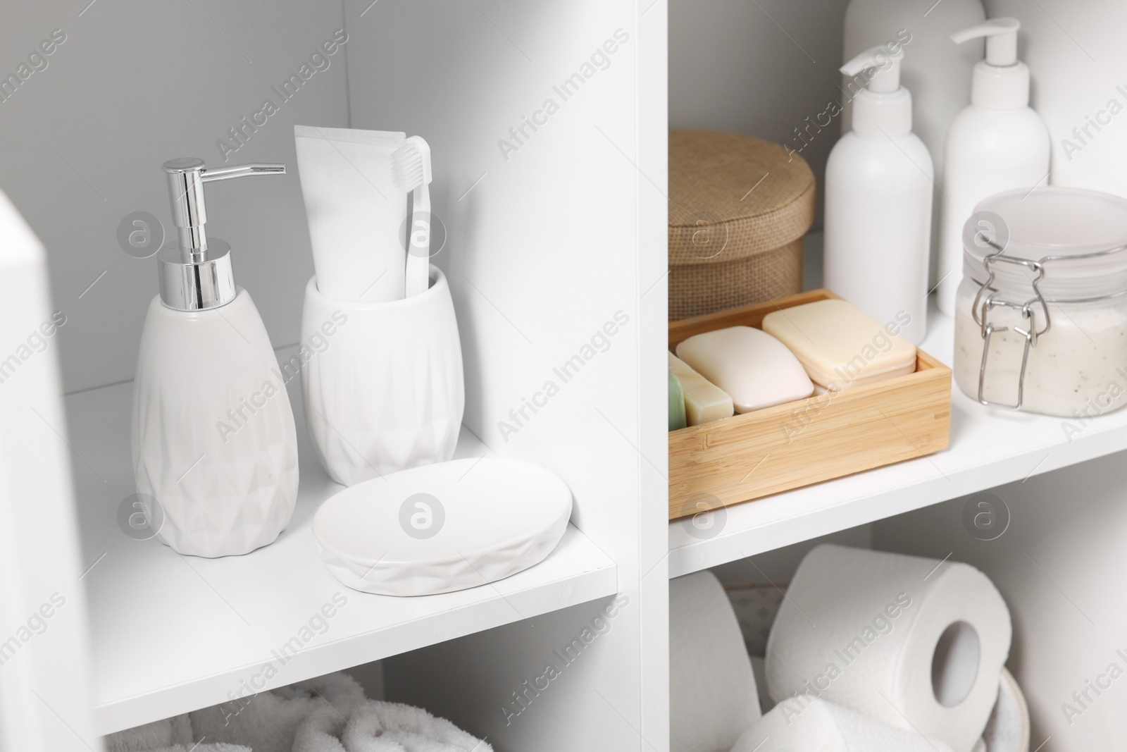 Photo of Different personal care products and bath accessories in bathroom vanity