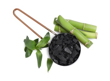 Photo of Fresh bamboo and charcoal on white background, top view