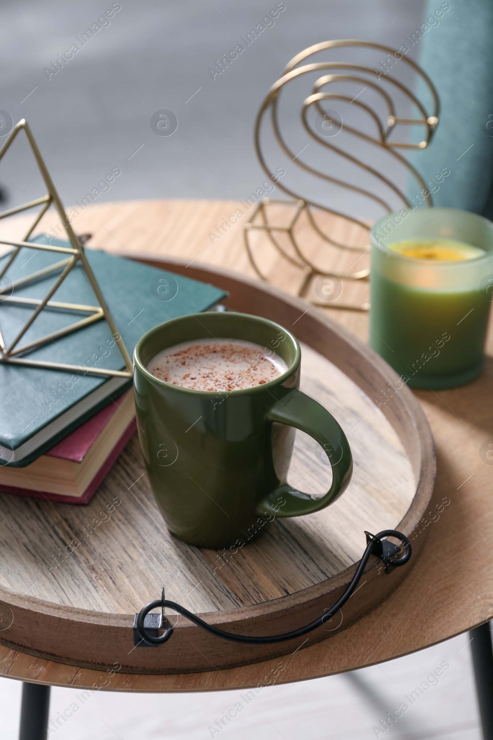 Photo of Stylish tray with different interior elements and coffee on wooden table indoors