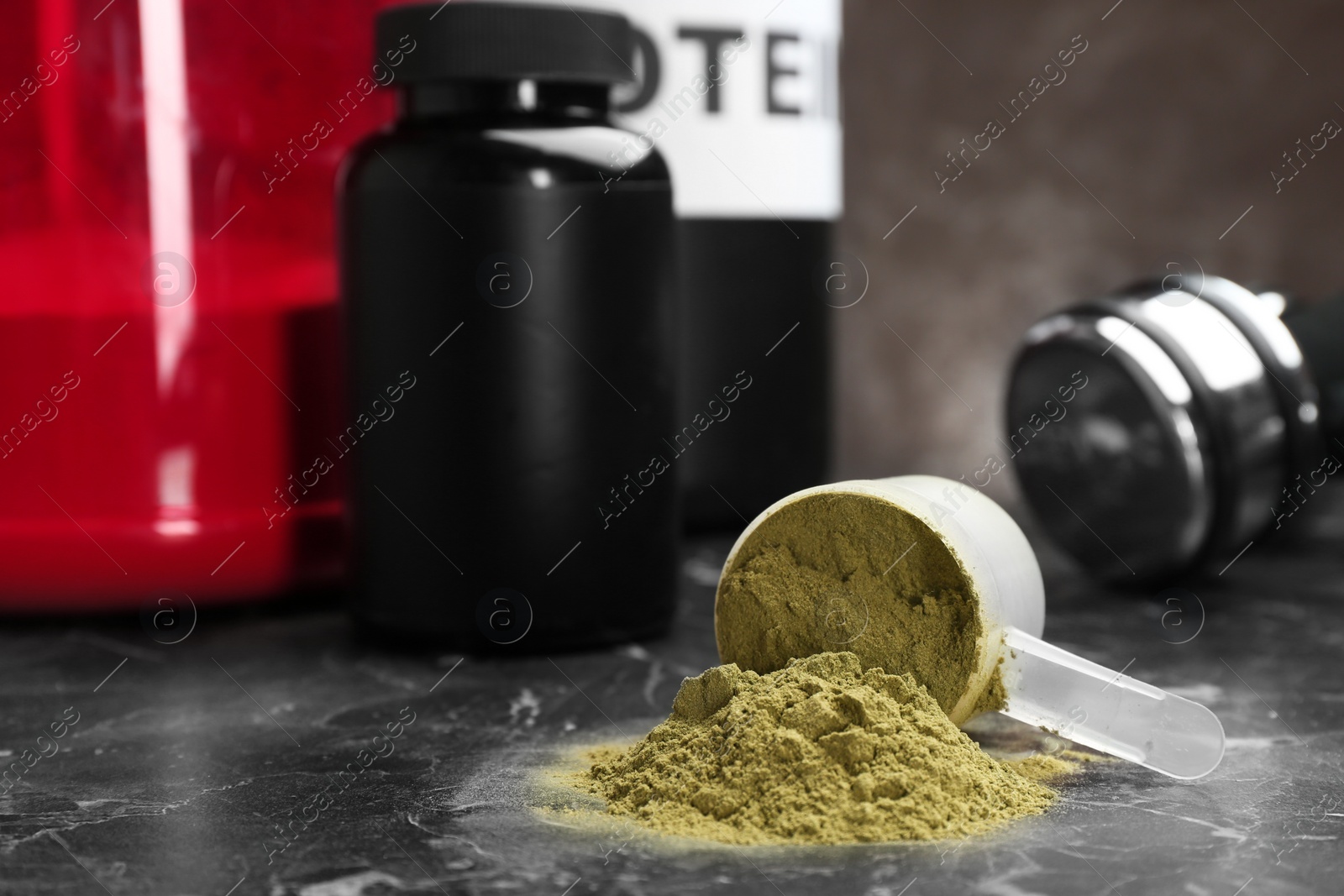 Photo of Measuring spoon with hemp protein powder on table. Space for text