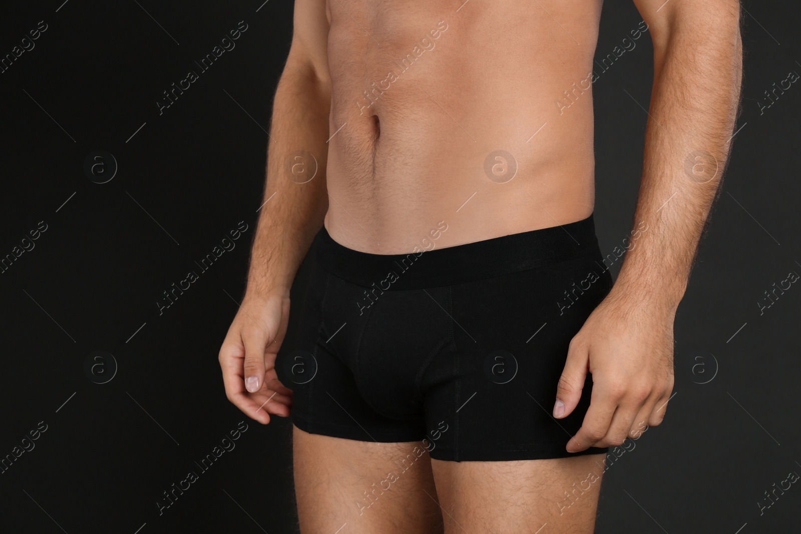 Photo of Man in underwear on black background, closeup