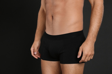 Photo of Man in underwear on black background, closeup